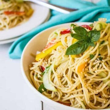 Thai Pasta Salad topped with a fresh sprig of basil