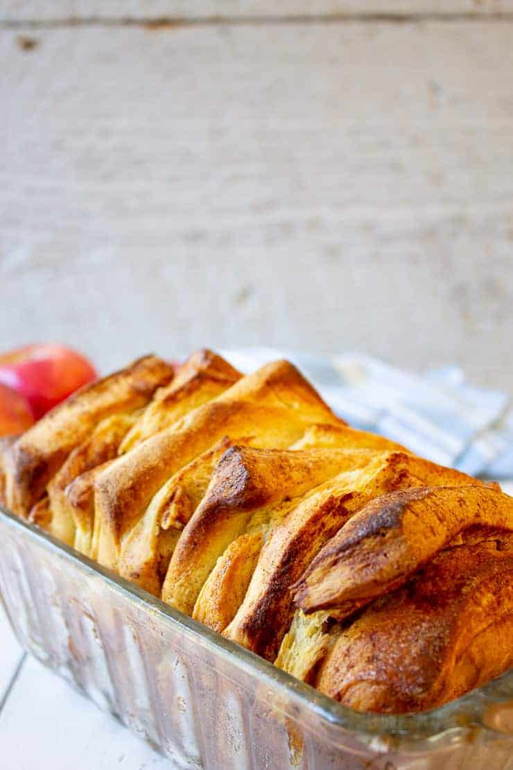 Apple bread cooling in a bread pan.