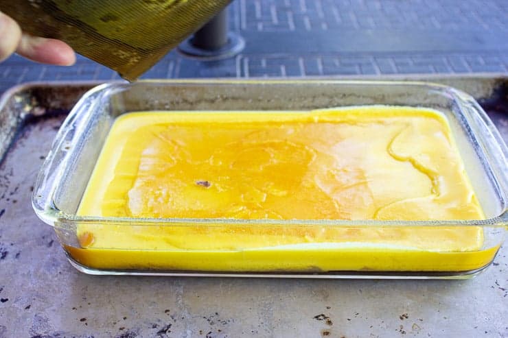 Yellow beeswax in a glass dish. 