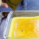 Yellow beeswax in a glass baking dish.