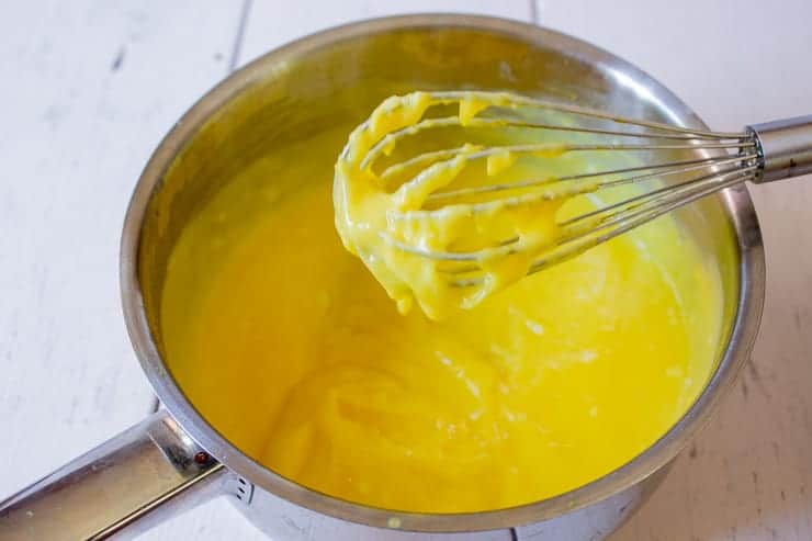 Lemon curd on a small whisk.