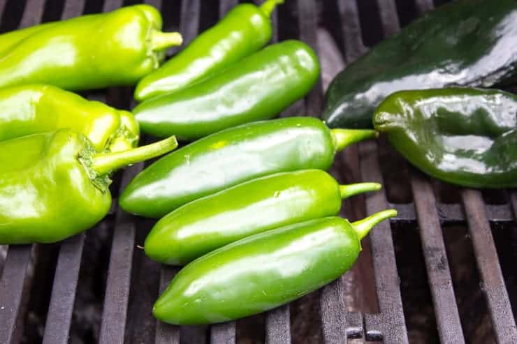 Jalapeno peppers on a gas grill.