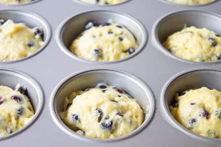 Muffin batter in a muffin tin.