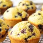 Muffins with berries on a baking rack.