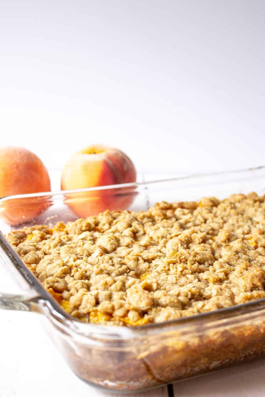 A glass casserole dish filled with peach bars. 