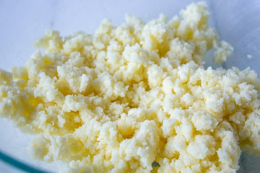 Butter and sugar combined in a bowl.