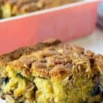 Blueberry coffee cake on a small white plate.