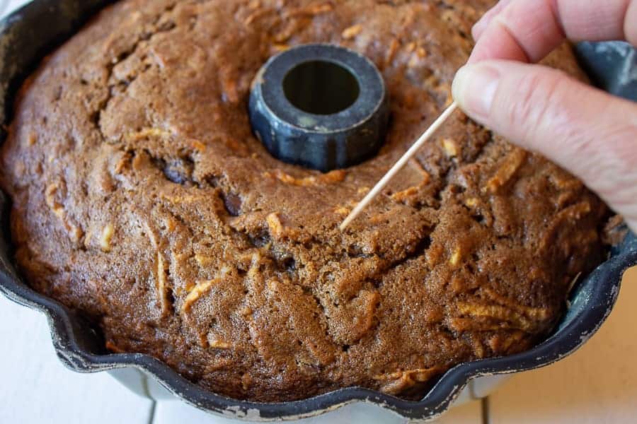 A toothpick testing to see if a chocolate cake is done.