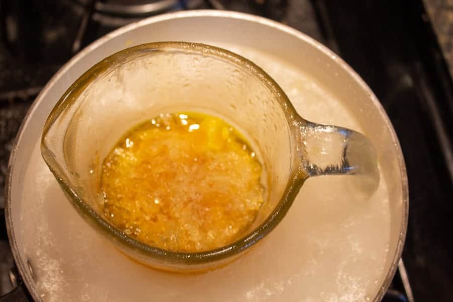 Melting beeswax in a glass measuring cup.
