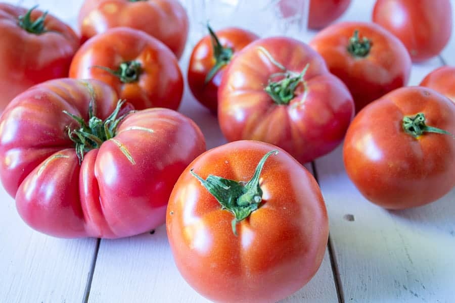 Fresh tomatoes on a white board.