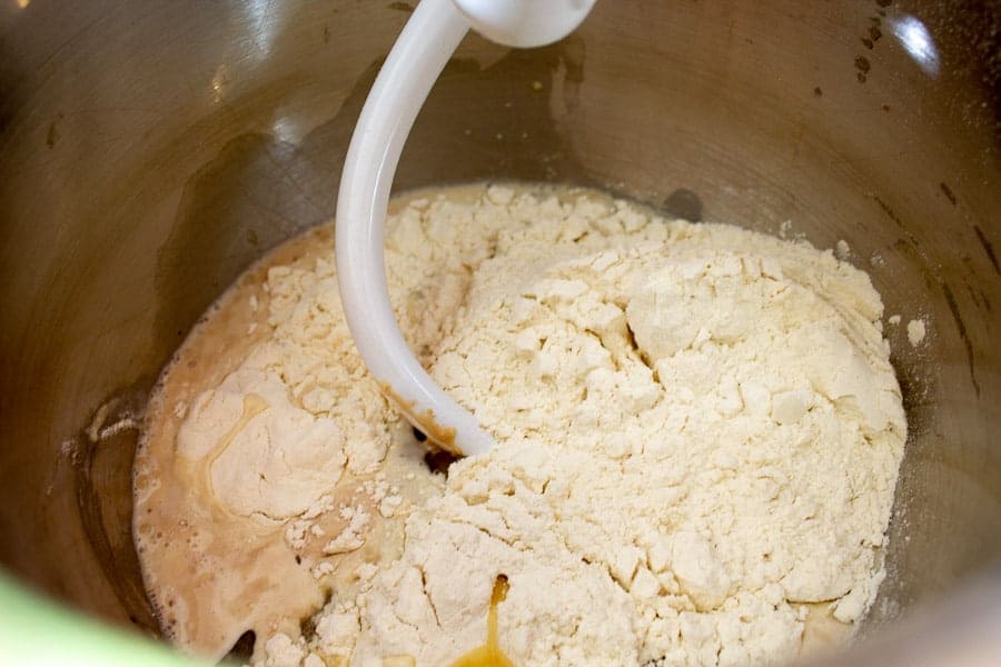 Flour added to a mixing bowl.