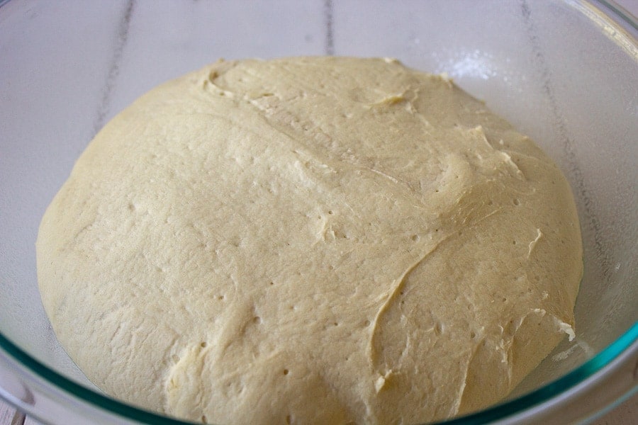 Dough fully proofed sitting in a glass bowl. 