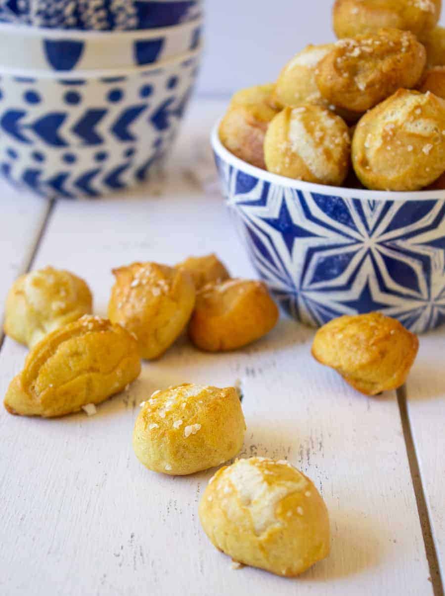 Soft pretzels sprinkled with salt on a white board. 