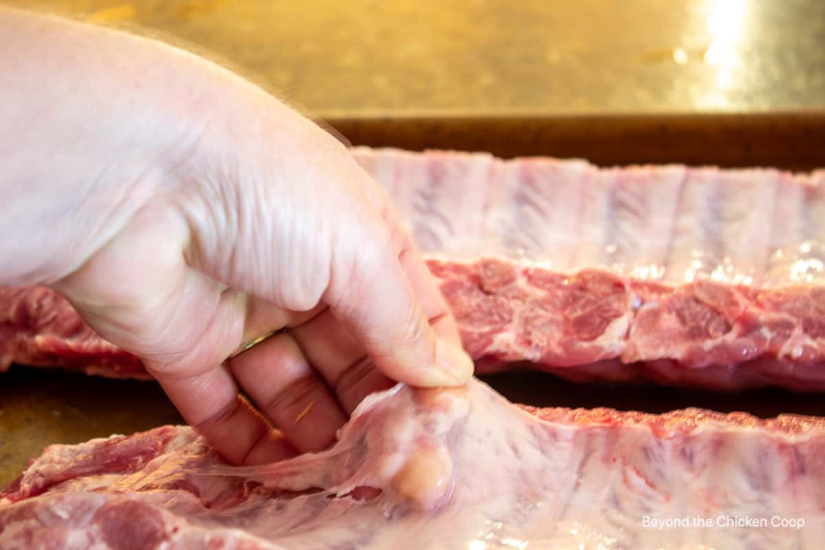 Removing the silverskin from a rack of ribs.