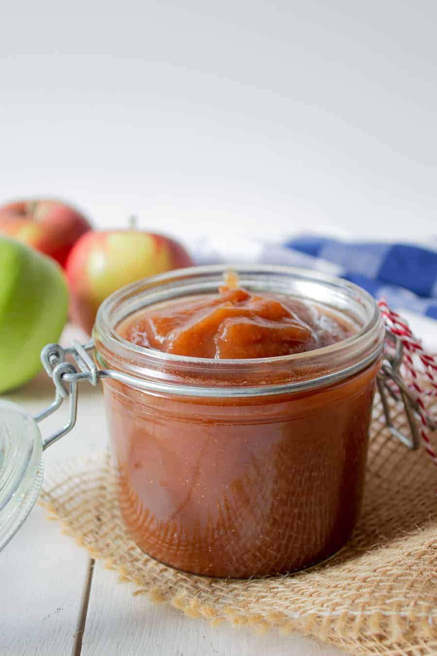 Apple butter in a glass crock.