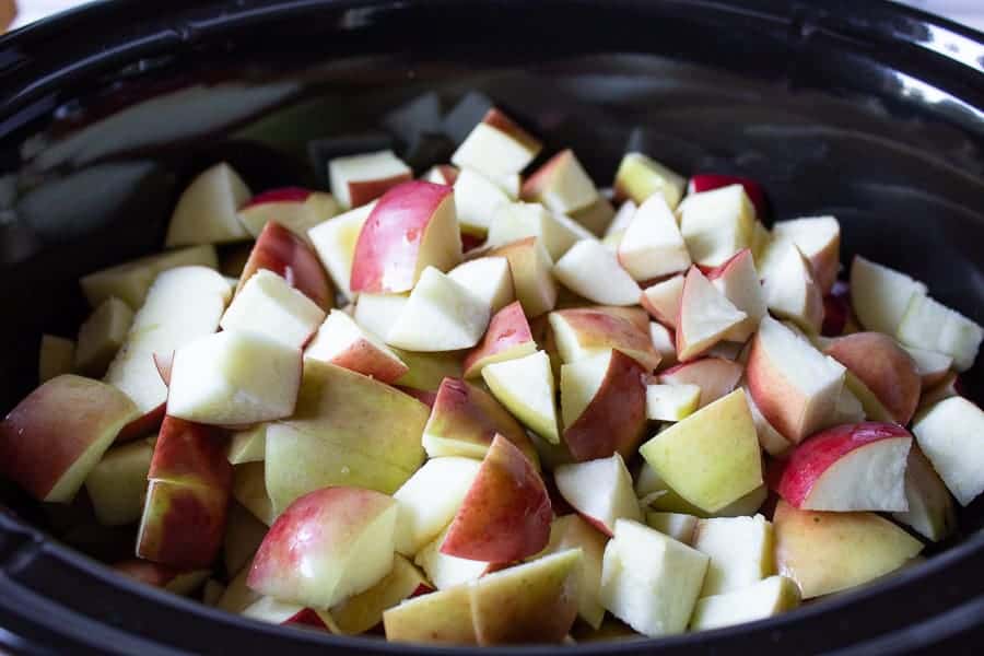 Chopped apples in a slow cooker.