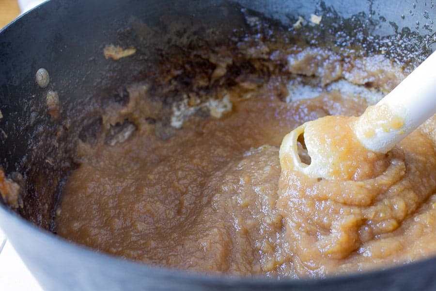 Pureeing a mixture with an immersion blender.