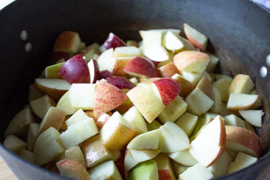 Chopped apples in a black pot. 