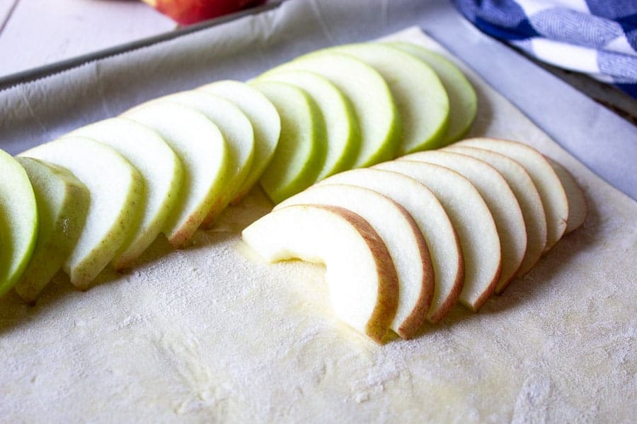 Fresh apple slices on top of a puff pastry.