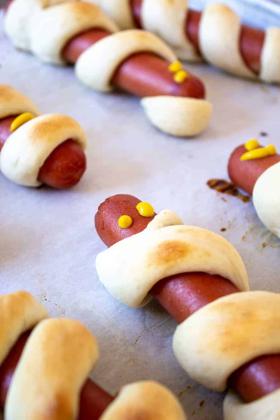 Hot dogs with mustard eyes.
