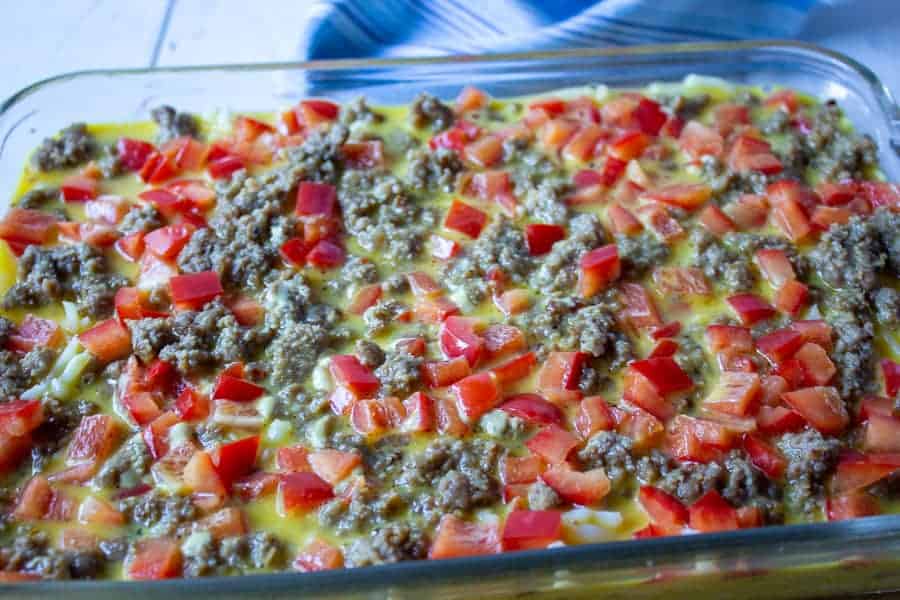 Uncooked breakfast casserole in a glass baking dish. 