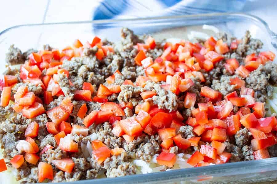 Breakfast sausage and fresh chopped bell peppers in a casserole. 