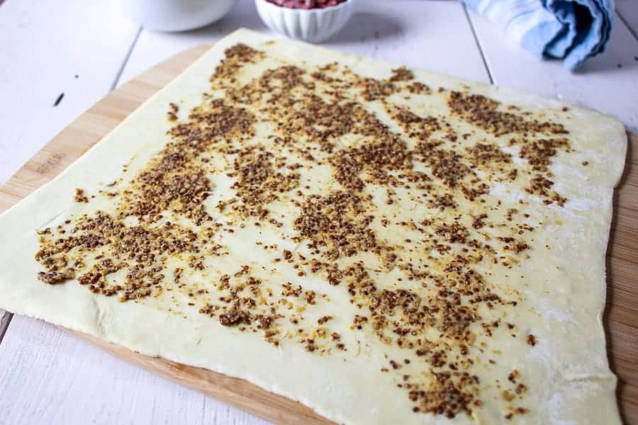 Puff pastry covered with a coarse ground mustard.