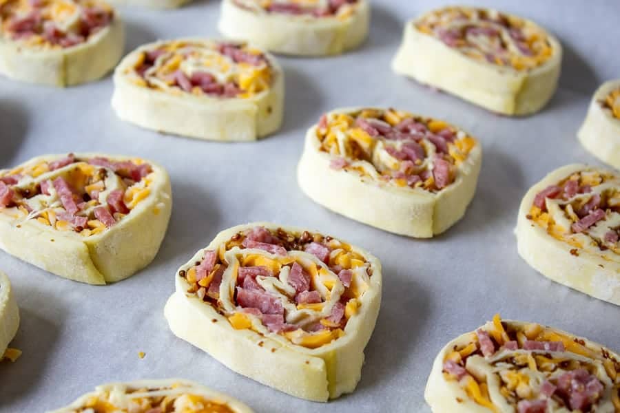 Salami and Cheese Pinwheels on a baking sheet.