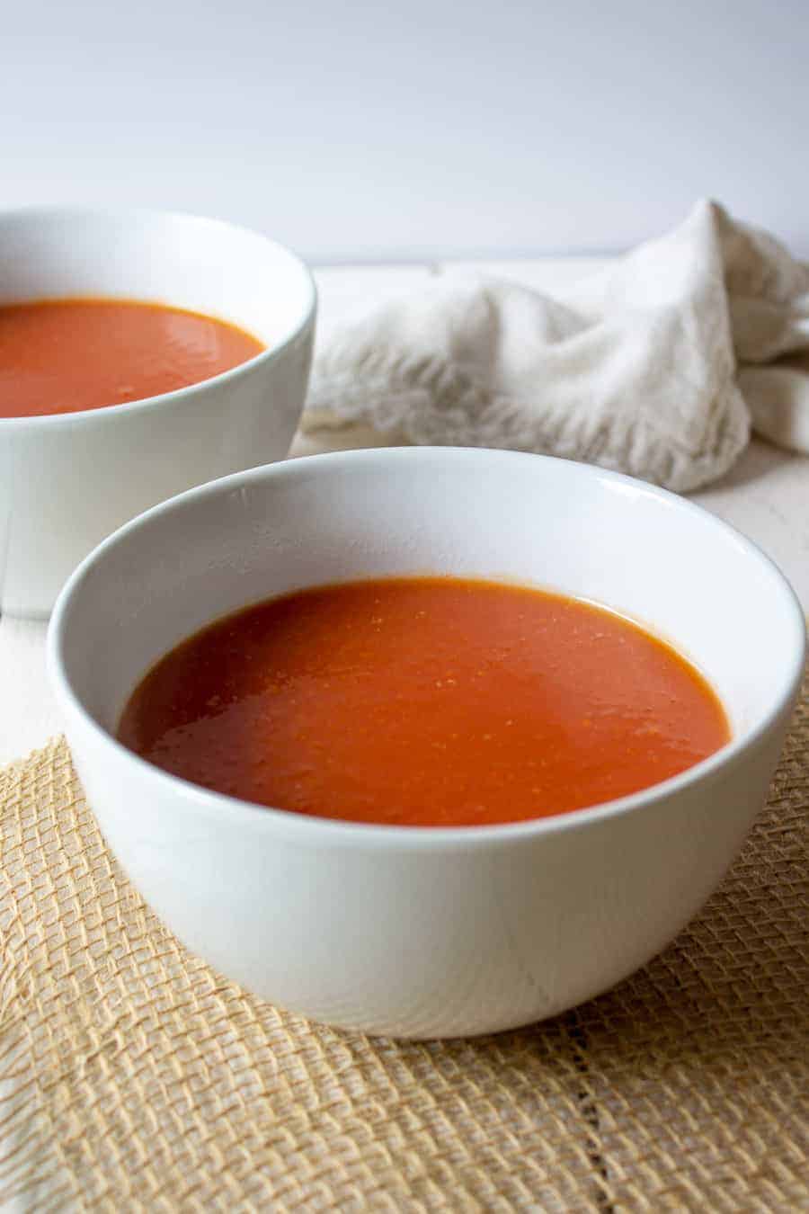 Two white bowls filled with soup.