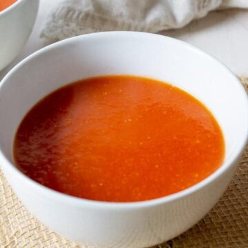 Tomato soup served in a white bowl.