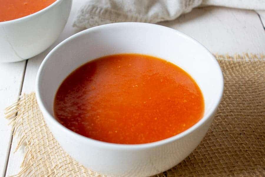 Tomato soup served in a white bowl.