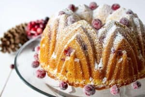 Bundt cake topped with sugared cranberries.