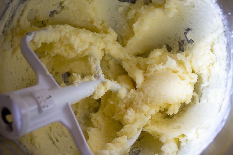 Butter and sugar mixed together in a mixing bowl.