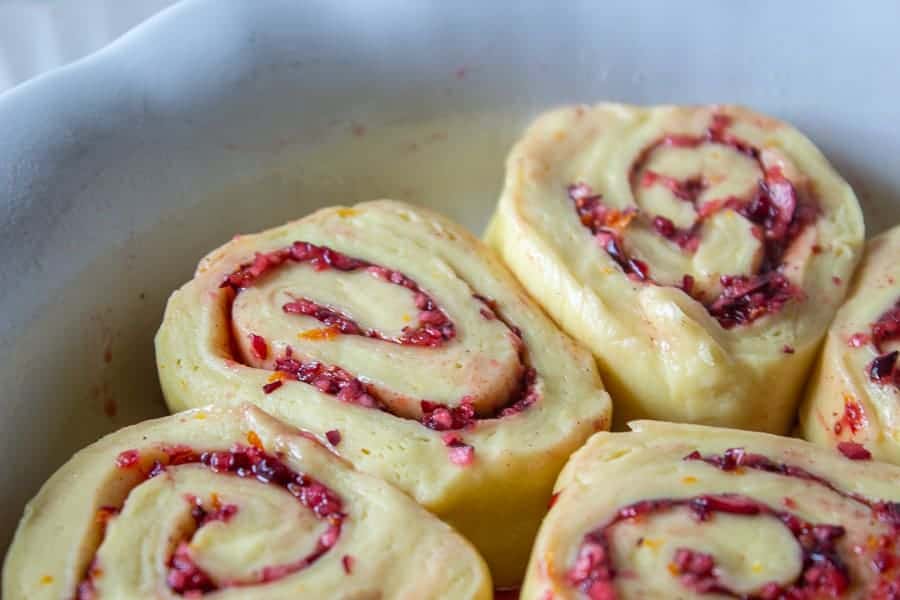 Slices of sweet rolls in a baking dish. 