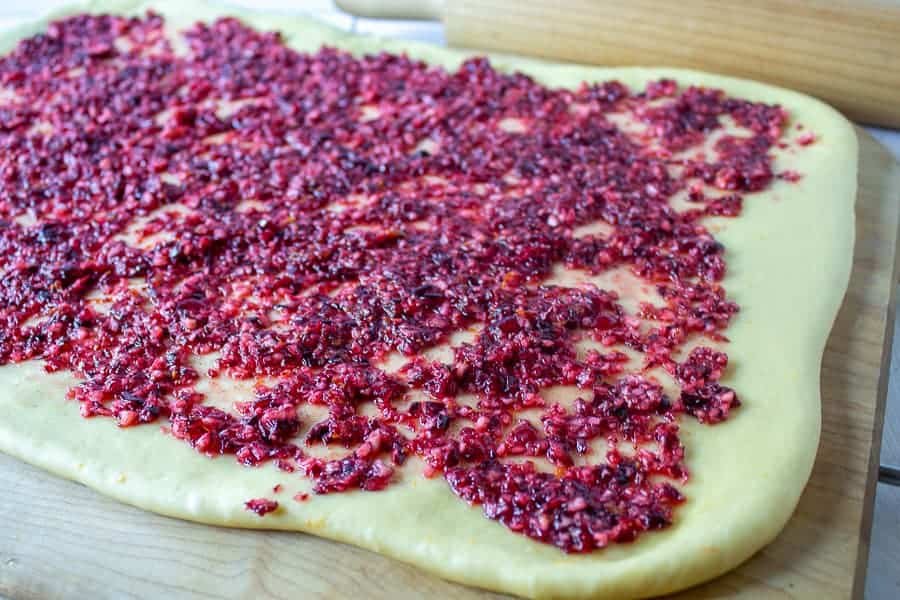 Chopped cranberries on bread dough. 