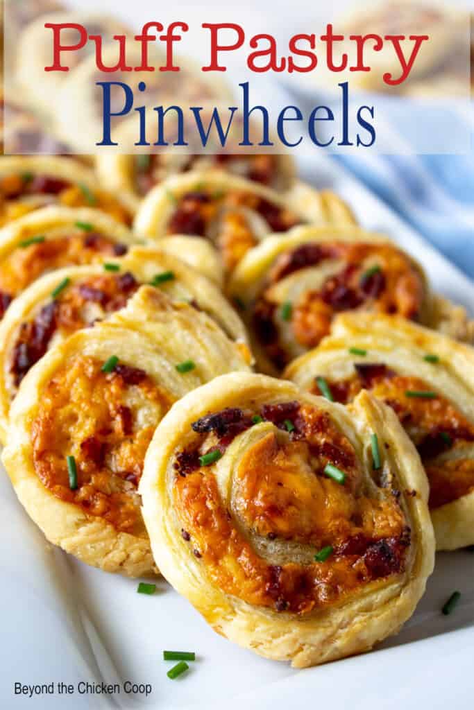 A platter filled with appetizers with puff pastry and cheese.