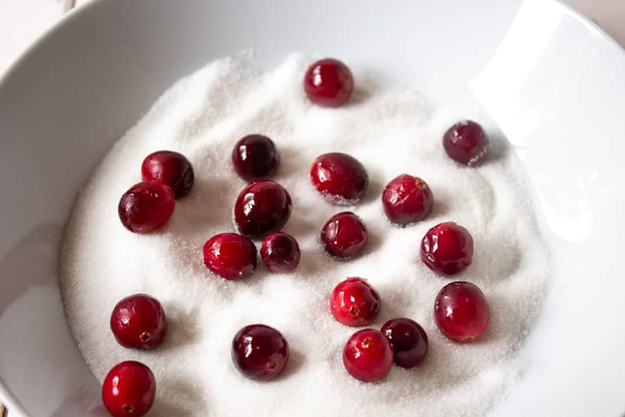 Cranberries in a bowl of sugar.