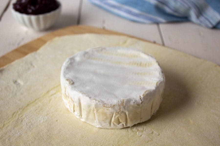 A round of brie on top of puff pastry dough.