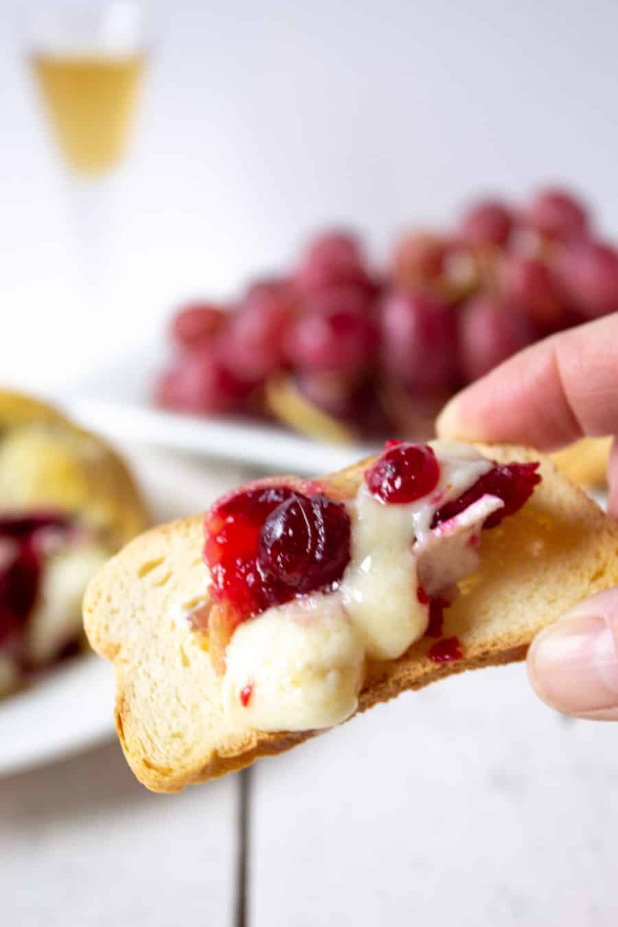Toasted bread topped with brie and cranberries. 