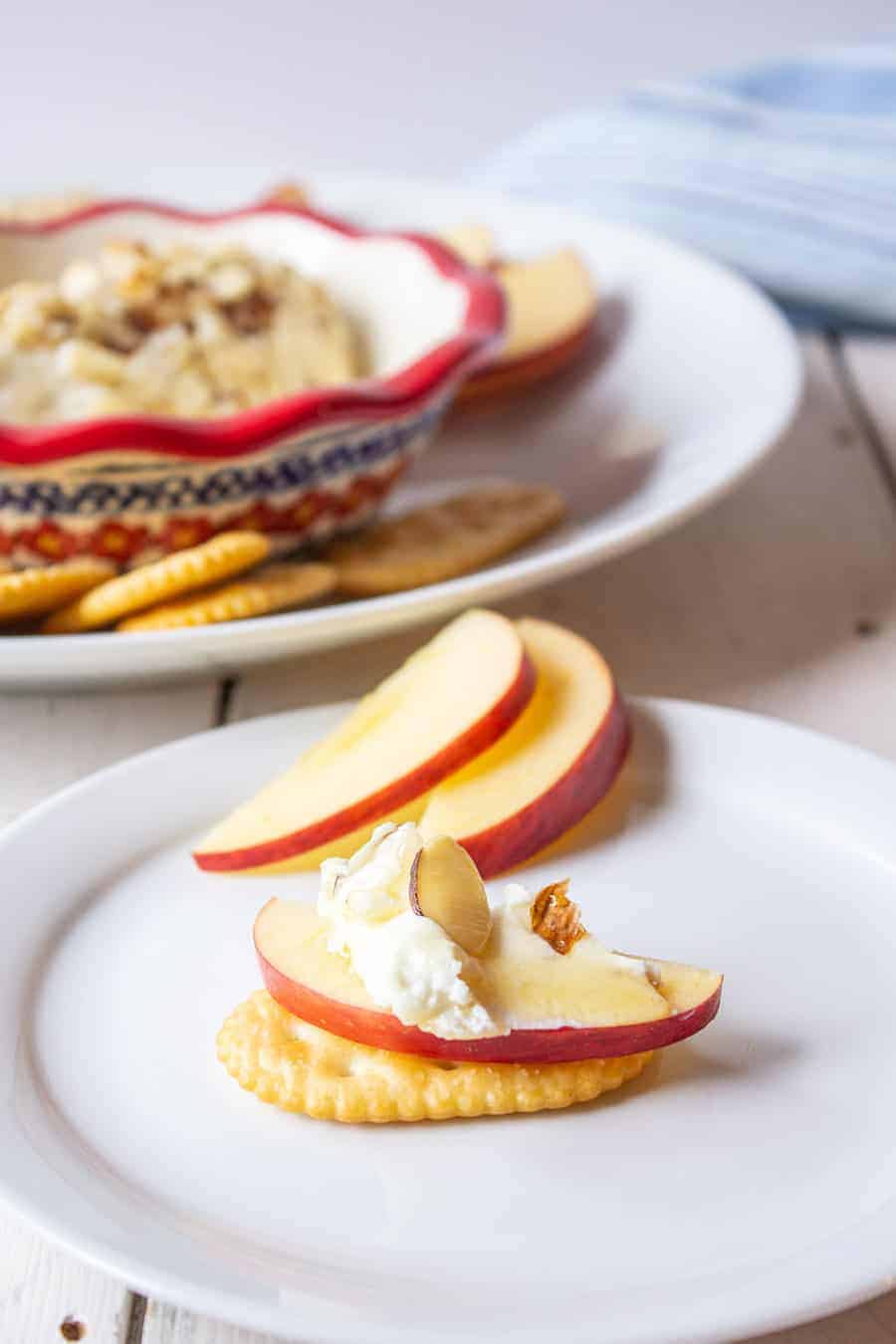 Crackers, apples and cheese topped with honey. 