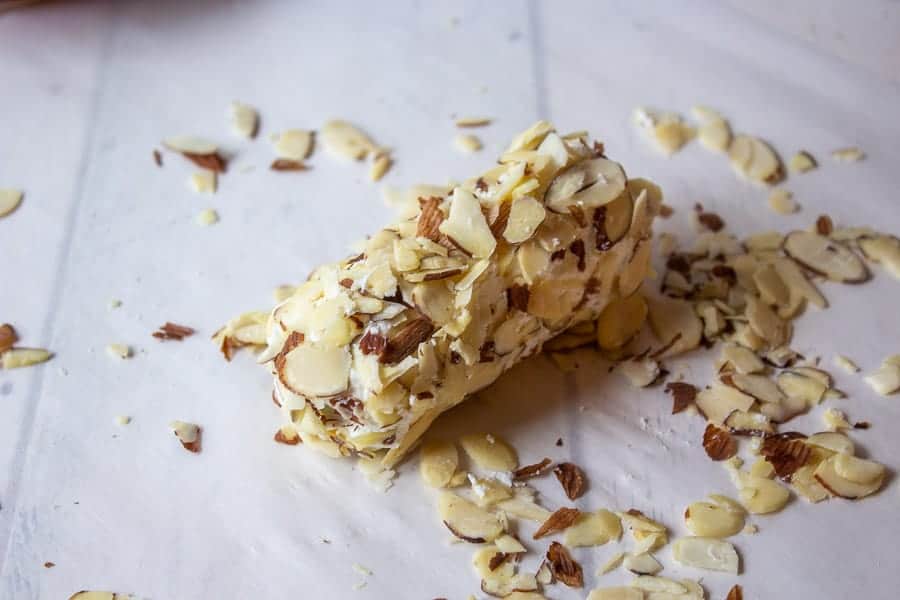 Cheese log rolled in sliced almonds.