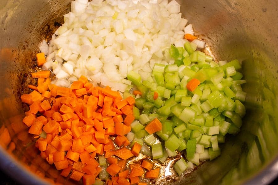 Chopped onions, celery and carrots in a stock pot.