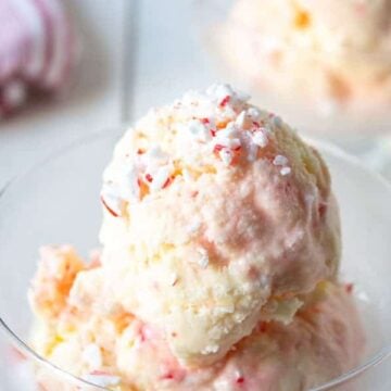Scoops of pink swirled ice cream in a glass dish.