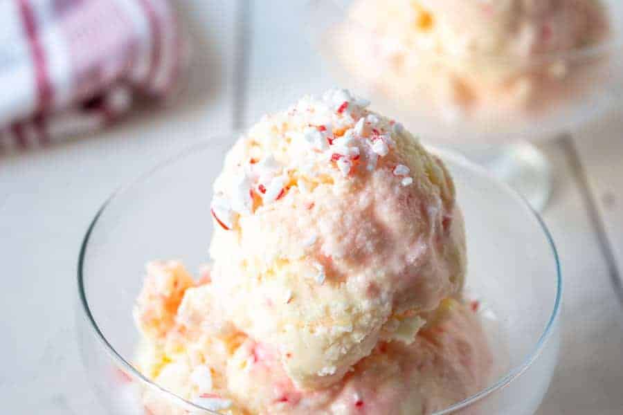 Scoops of pink swirled ice cream in a glass dish.
