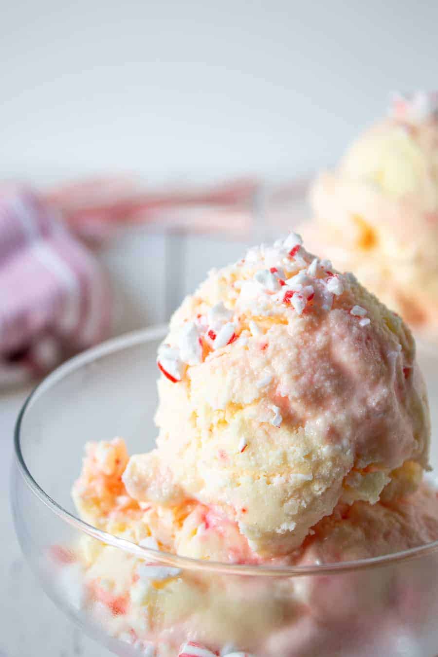 Large scoops of candy cane ice cream in glass dishes. 