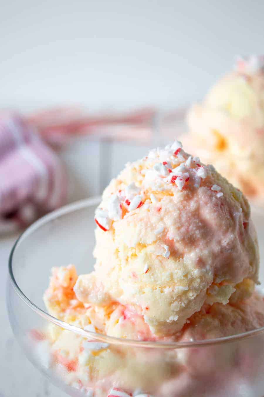 Large scoops of candy cane ice cream in glass dishes. 