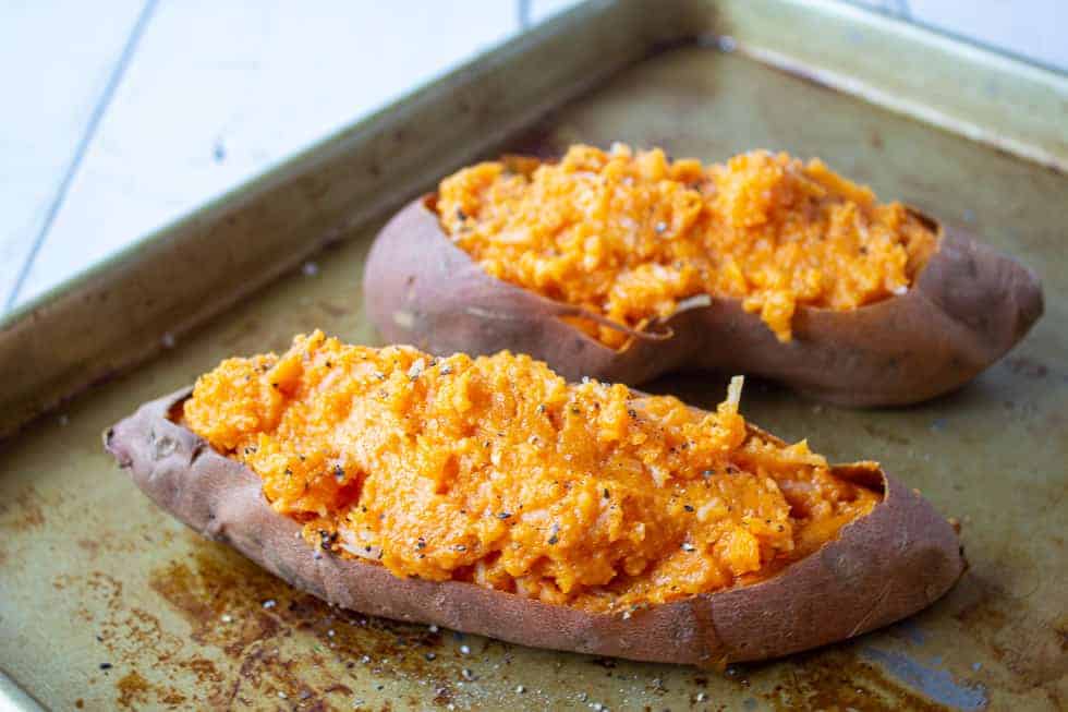 Mashed sweet potatoes in potato skins.