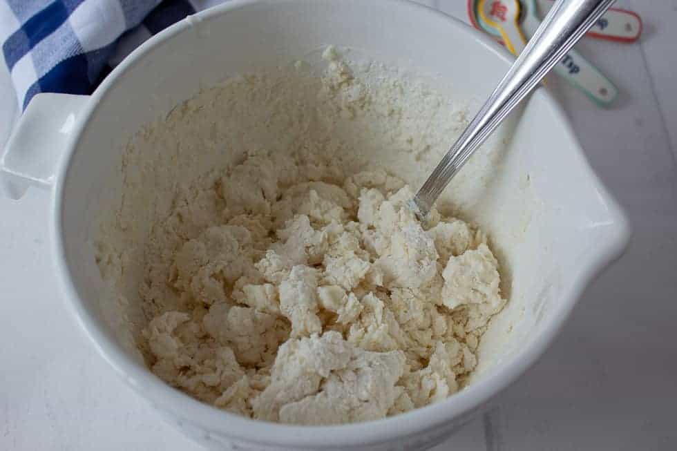 Biscuit dough in a white bowl.