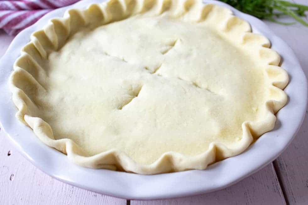 Slices in the top of an uncooked pie crust.