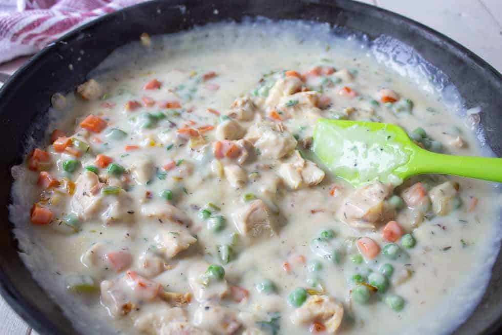 Creamy chicken and veggie mixture in a pot.